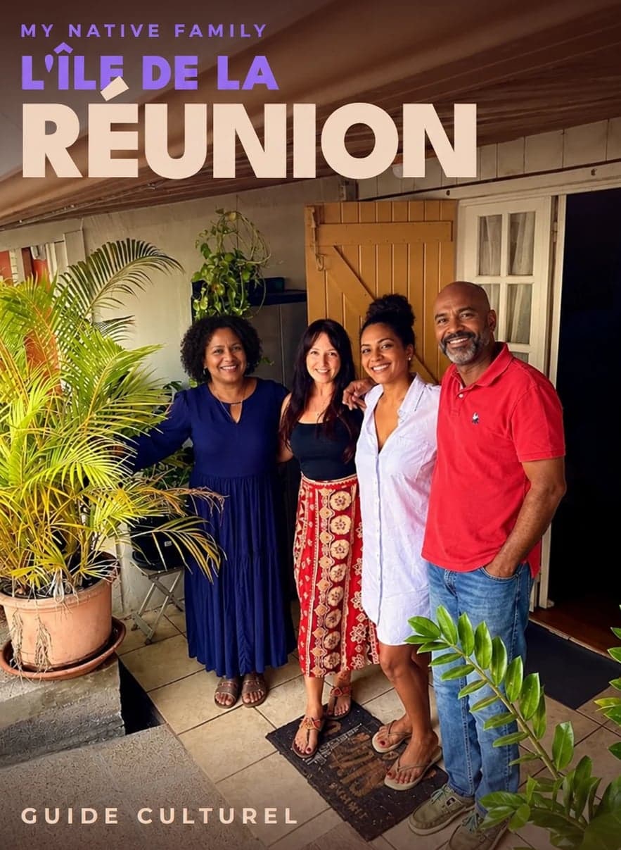 Quatre habitants de La Réunion souriants devant leur case créole